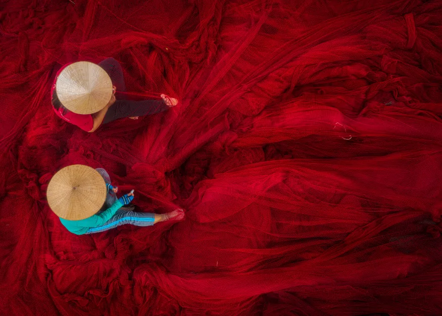 Women working on mesh netting – Grand Tour of Vietnam 2026-27, Guiness Travel escorted tour